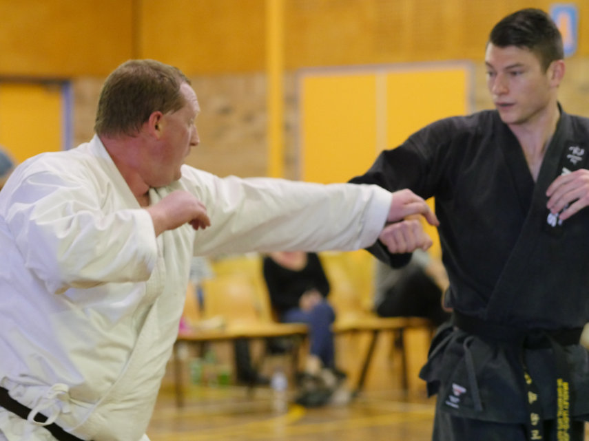 Black belt and black tip martial artists sparring