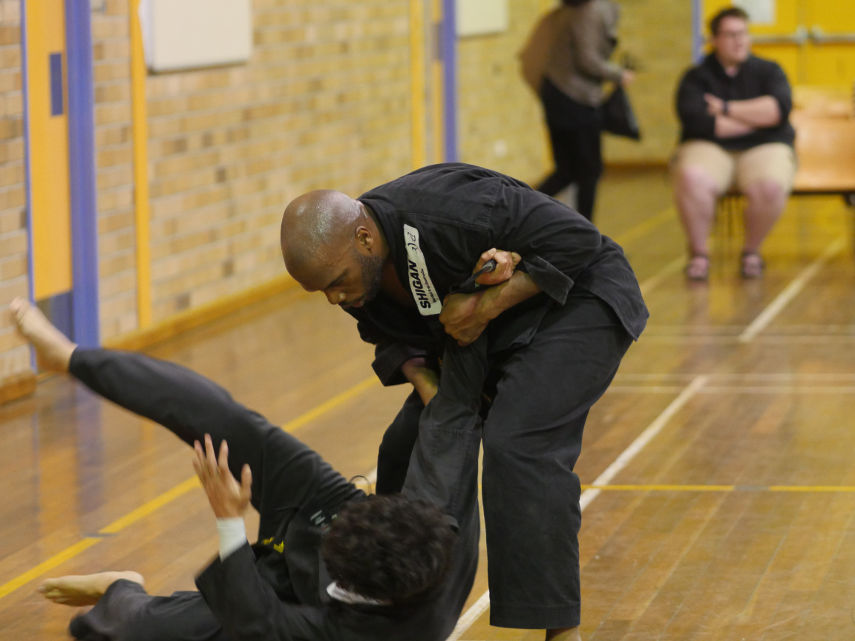 Senior black belts practicing wrestling techniques